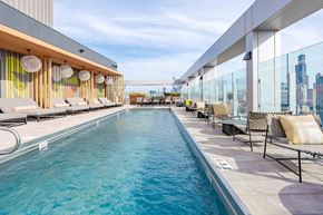 Chicago apartment for rent - A long rectangular pool with a glass barrier on one side.