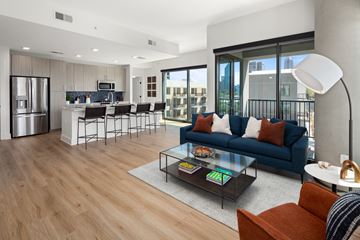 Atlanta apartment for rent - a living room and kitchen with a blue couch and a coffee table