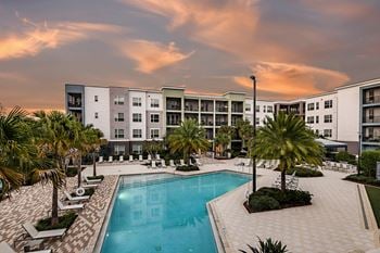 Pool with sun shelf, private cabanas, and poolside lounge