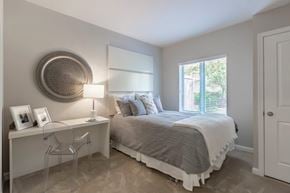 North Bethesda apartment for rent - A bedroom with a bed, desk, chair, and window.