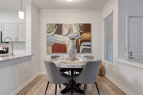 San Antonio apartment for rent - a dining room with a table and chairs and a painting on the wall