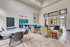 San Antonio apartment for rent - the reserve at bucklin hill clubhouse with tables and chairs and a kitchen in the background