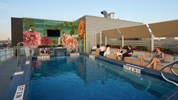 Boston apartment for rent - People are sitting on the sun loungers by the pool.