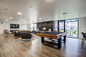 Seattle apartment for rent - a community room with a pool table and a tv