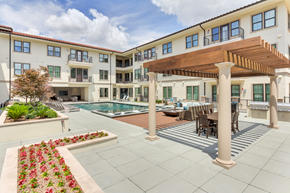 Dallas apartment for rent - a backyard with a pool and patio with a wooden awning