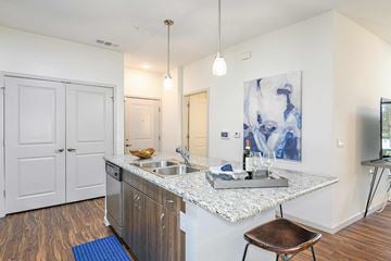 Windermere apartment for rent - A kitchen with a white counter top and a brown stool.