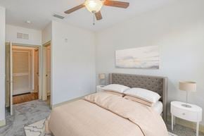 Maitland apartment for rent - a bedroom with a bed and a ceiling fan