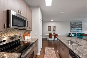 Orlando apartment for rent - A kitchen with a stove top oven and microwave.