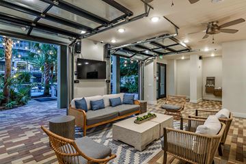 Orlando apartment for rent - A living room with a grey sofa and a wooden coffee table.