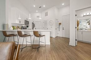 Charlotte apartment for rent - A kitchen with white cabinets and a wooden floor.