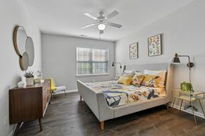 Fairfax apartment for rent - A bedroom with a bed, dresser, and mirror.