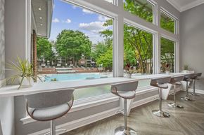 Fairfax apartment for rent - a dining room with a large window overlooking a pool