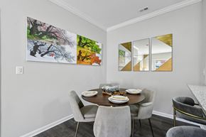 Fairfax apartment for rent - A dining room with a table set for two and a large abstract painting on the wall.