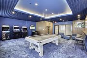 Jersey City apartment for rent - A room with a pool table and arcade games.
