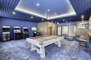 Jersey City apartment for rent - A room with a pool table and arcade games.