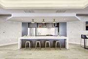 Jersey City apartment for rent - A modern kitchen with a white island and stools.