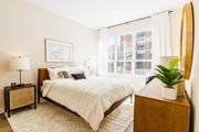 Jersey City apartment for rent - a bedroom with a bed and a large window at One Ten Apartments, New Jersey, 07310
