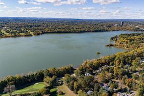 Pearl River apartment for rent - A large body of water surrounded by trees and buildings at The Reserve at Pearl River Apartments, Pearl River, NY, 10965
