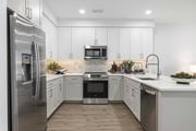 Hillsdale apartment for rent - A modern kitchen with a refrigerator on the left and a sink on the right.