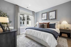 Hillsdale apartment for rent - Bedroom with white bedding and large window at The Piermont Apartments, Hillsdale, New Jersey