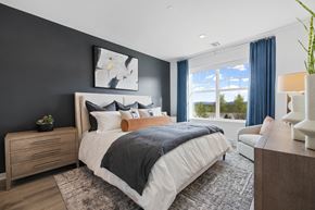 Pearl River apartment for rent - A bedroom with a large bed, a nightstand, and a chair at The Reserve at Pearl River Apartments, Pearl River, 10965
