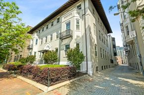 Washington apartment for rent - a grey apartment building with a brick sidewalk in front of it