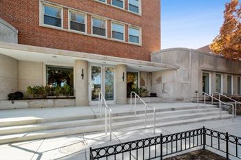 A large brick building with a staircase in front of it