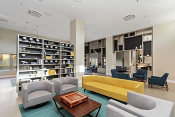 A community lounge room filled with furniture and a large bookshelf