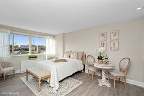 Washington apartment for rent - a bedroom with a large bed and a large window