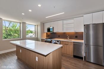 A kitchen with an island and stainless steel appliances