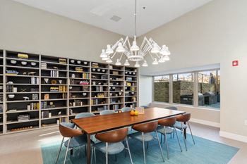 A conference room with a large bookshelf in the background