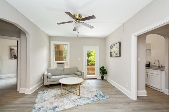 Washington apartment for rent - a living room with a couch coffee table and a ceiling fan