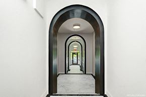 Washington apartment for rent - a view down a hallway with a black and white archway and white walls