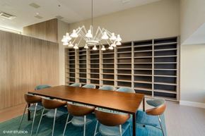 Washington apartment for rent - Conference Room with a long wooden table and blue chairs at Carver and Slowe Apartments, Washington Washington, DC