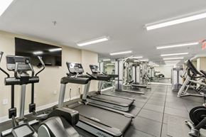Washington apartment for rent - a gym with cardio machines and a flat screen tv at Carver and Slowe Apartments, Washington