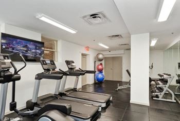 A gym with treadmills and other exercise equipment