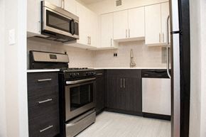 Washington apartment for rent - a kitchen with stainless steel appliances and white cabinets
