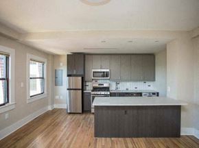 Washington apartment for rent - a kitchen with a stove a refrigerator and a microwave
