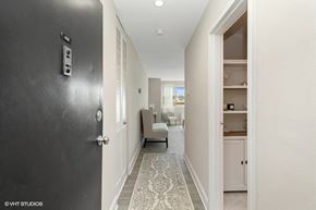 Washington apartment for rent - a hallway with a black door and a rug on the floor