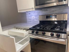 Washington apartment for rent - a kitchen with a stove top oven next to a microwave
