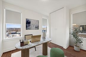 Washington apartment for rent - an office with a desk with a laptop and a window