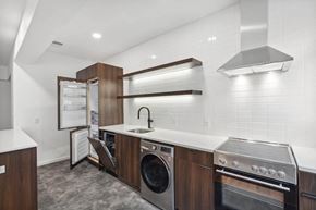 Washington apartment for rent - a kitchenette with white countertops and wooden cabinetry