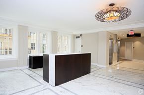 Washington apartment for rent - a large lobby with a reception desk and a large chandelier