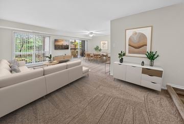 Rockville apartment for rent - A living room with a large couch, a coffee table, and a painting on the wall.