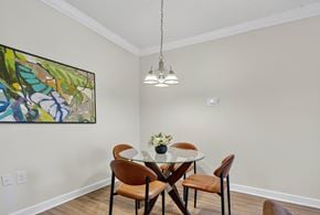 Washington apartment for rent - A dining room with a table set for two and a painting on the wall.