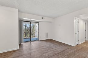 Washington apartment for rent - A room with a sliding glass door leading outside.