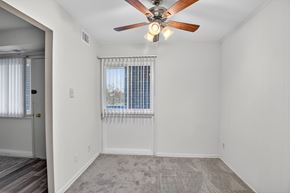 Landover apartment for rent - A  dining room with a ceiling fan and a window with blinds.