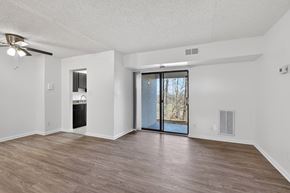 Washington apartment for rent - A room with a sliding glass door leading to a backyard.