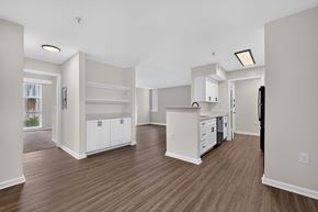 Frederick apartment for rent - A kitchen with white cabinets and a wooden floor.