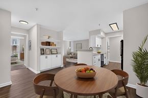 Frederick apartment for rent - A modern kitchen with a wooden table and chairs.
